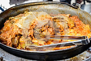 Freshly cooked large portion of cabbage rolls with meat and cabbage, a traditional Romanian food called sarmale cooked at a food m