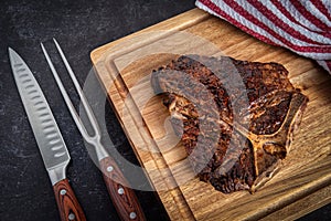 Freshly cooked porterhouse steak and carving set