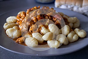 Freshly cooked potato gnocchi with shrimp sauce. Potato-based food rich in calories