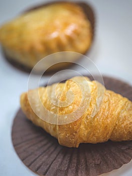 Freshly Croissant in baking paper, Vertical view