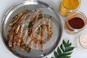 Freshly cut, cleaned and marinated anchovy fish presented on a steel plate photo