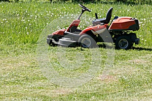 Freshly cut grass by red lawnmower