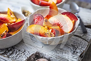 Freshly cut peaches in a white bowl