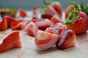 Freshly Cut Strawberries on Wooden Plate