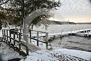 Freshly Fallen Snow on Walkway Bridge and Docks on a Lake