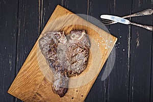 Freshly fried delicious meat T-bone steak on wooden board