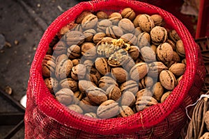 Freshly gathered Walnuts in a red sack