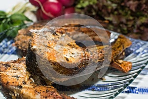 Freshly grilled fish on kitchen table. closeup, top view