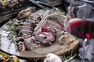 Freshly grilled T bone steak with vegetables on wooden cuting board