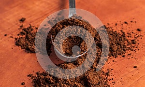 Freshly ground coffee in a slice over a kitchen red table