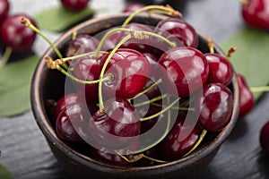 Freshly harvested cherries in a clay bowl from your home garden