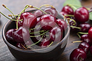 Freshly harvested cherries in a clay bowl from your home garden