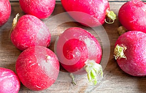 Freshly harvested radishes on a wooden surface