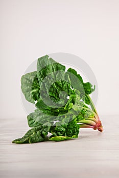 Freshly harvested spinach on white kitchen plate and napkin