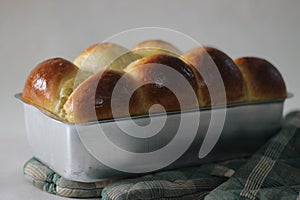 Freshly Home baked Brioche bun loaf inside the loft tin