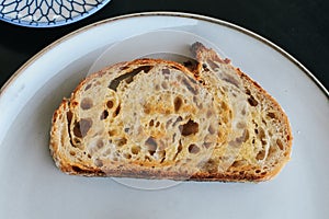 Freshly homemade baked sour dough rye bread sliced and served with jam and butter