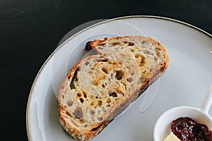 Freshly homemade baked sour dough rye bread sliced and served with jam and butter