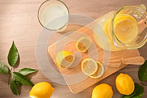 Freshly lemon juice with utensils on wooden kitchen bench top