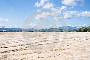 Freshly leveled construction site with mountains in background