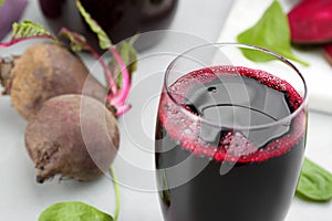 Freshly made beet juice in glass on table