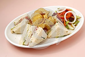 Freshly made clubhouse sandwich served with chips