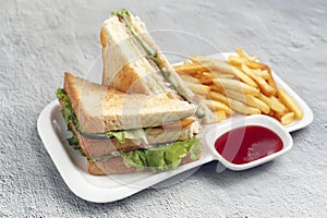 Freshly made Clubhouse sandwich served with french fries