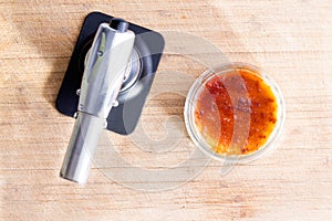 Freshly made creme brulee with a butane torch photo