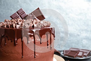 Freshly made delicious chocolate cake against background, closeup. Space for text