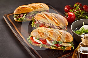 Freshly made gourmet sandwiches on wooden tray