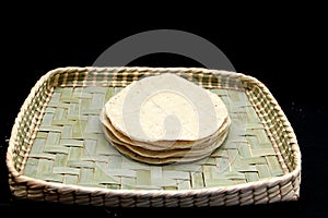 Freshly made and hot corn tortillas ready to eat and make Mexican tacos in a napkin to keep fresh