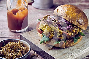 Freshly made insect burger with fried mealworms