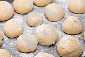 Freshly made white bread rolls proving