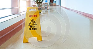 Freshly mopped hallway with a caution sign photo