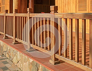 A freshly painted and stained wood deck with railing