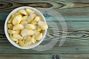 Freshly peeled aromatic garlic cloves in a ramekin photo