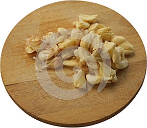 Freshly Peeled and Smashed Garlic on Round Cutting Board - Isolated