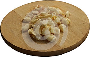 Freshly Peeled and Smashed Garlic on Wooden Cutting Board - Isolated