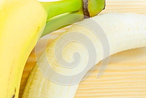 Freshly peeled and unpeeled banana close up