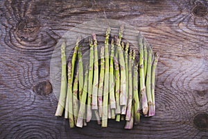 Freshly picked asparagus arranged on wooden table