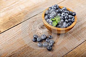Freshly picked blueberries in a wooden bowl. Healthy berry, organic food, antioxidant, vitamin