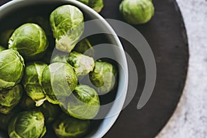 Freshly picked Brussels sprouts in vegetable garden in ceramic bowl