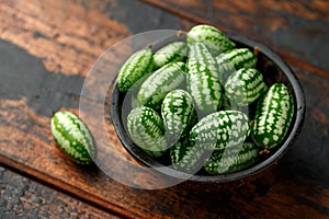 Freshly picked Cucamelon in rustic bowl on wooden table