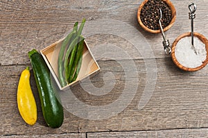 Freshly picked, ripe, raw, vegetables and wood bowls of sea salt and fresh pepper corns