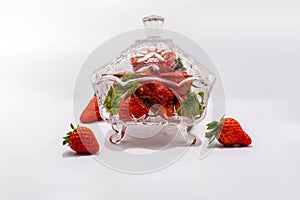 Freshly picked strawberries in a closed glass bowl to keep them fresh and full of nutrients, this fruit is ideal for diets