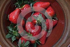 Freshly picked summer strawberries in a rustic bowl