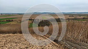 Freshly plowed field. Arable land with fertile soil for planting wheat. Rural landscape in Serbia, Balkans, namely Fruska Gora