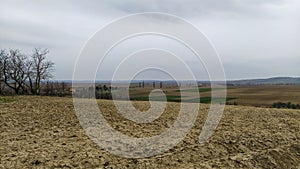 Freshly plowed field. Arable land with fertile soil for planting wheat. Rural landscape in Serbia, Balkans, namely Fruska Gora