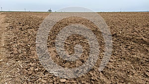 Freshly plowed field. Arable land with fertile soil for planting wheat. Rural landscape in Serbia, Balkans, namely Fruska Gora