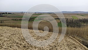 Freshly plowed field. Arable land with fertile soil for planting wheat. Rural landscape in Serbia, Balkans, namely Fruska Gora