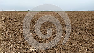 Freshly plowed field. Arable land with fertile soil for planting wheat. Rural landscape in Serbia, Balkans, namely Fruska Gora